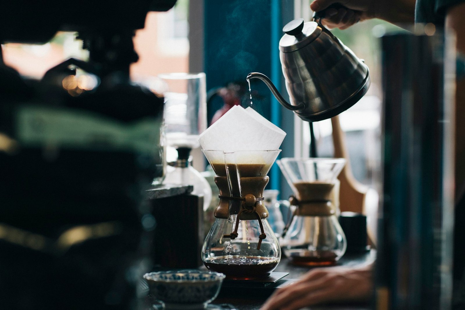 A barista brewing pour-over coffee at the Halden roastery bar