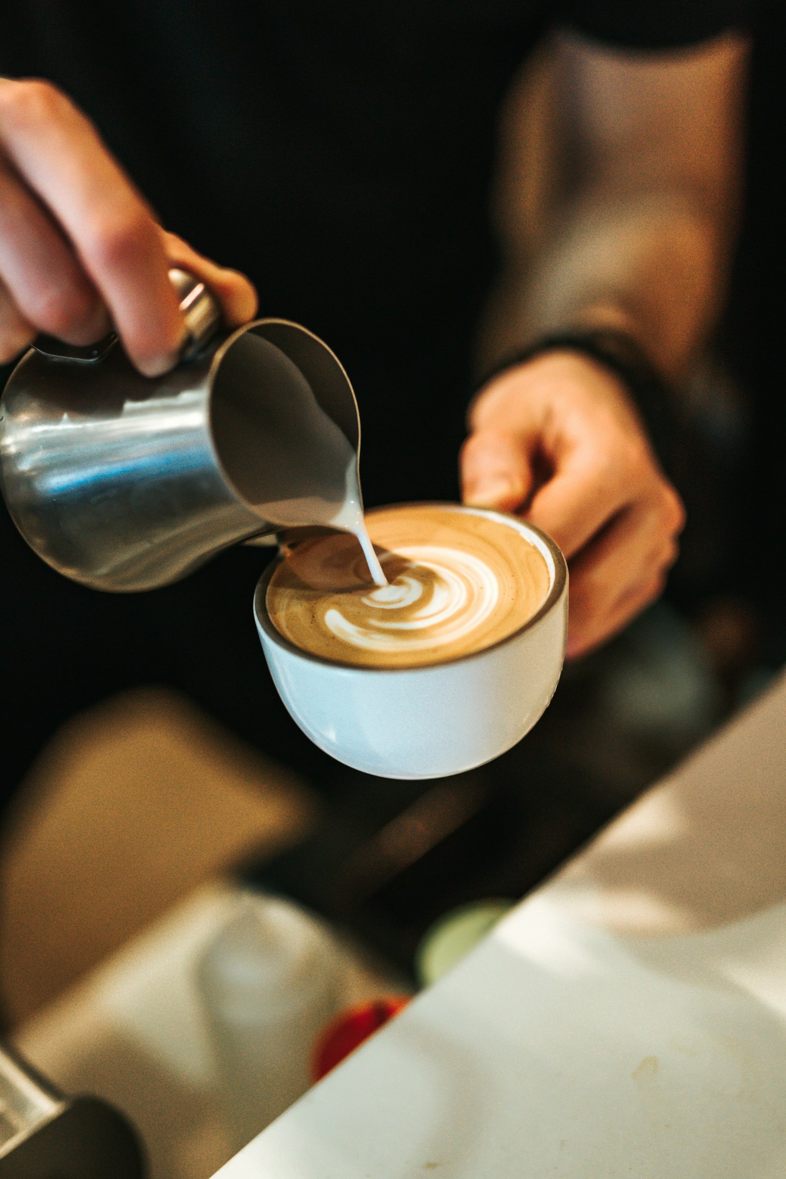 Milk being poured into a latte